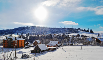 Winter landscape. Little snow-covered wooden houses. Ukraine, Karpaty.