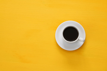coffe cup on wooden yellow background