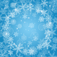 Abstract light blue Christmas background with snowflakes.