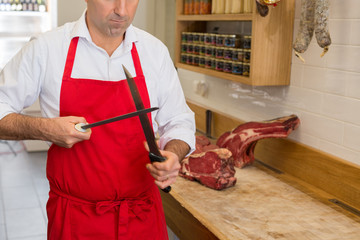 butcher sharpening the knife