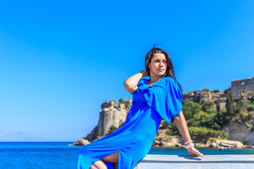 beautiful greek young brunet woman in blue dress