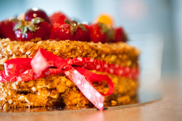 Delicious tart with fresh strawberries, raspberries and currants on the table.