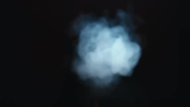 CU female exhaling smoke from a vapor into the camera. 4K UHD RAW edited footage