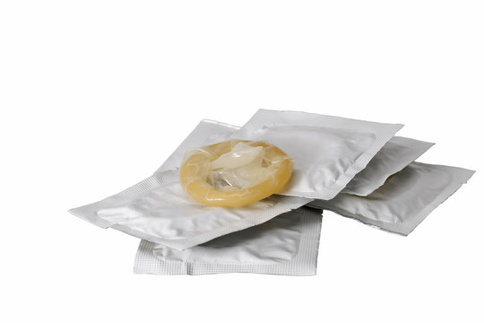 heap of latex condoms isolated on white