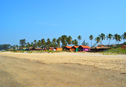 Multi-colored hut on a sandy beach of the Indian Ocean in Goa