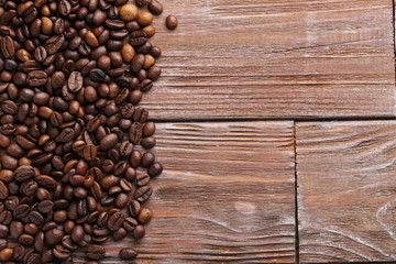 Roasted coffee beans on a brown wooden table