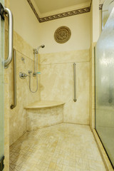 Close up of large walk-in shower with marble tile