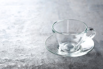 Empty glass on a grey wooden table