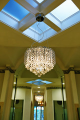 Beautiful chandelier on the ceiling with skylights. Bathroom interior. Northwest, USA