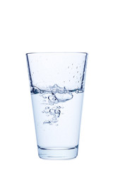 Water pouring in glass isolated on a white