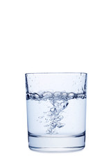 Water pouring in glass isolated on a white