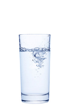 Water pouring in glass isolated on a white