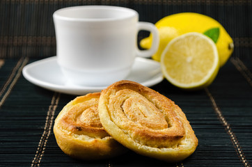 cup of hot black tea, lemon, homemade cookies