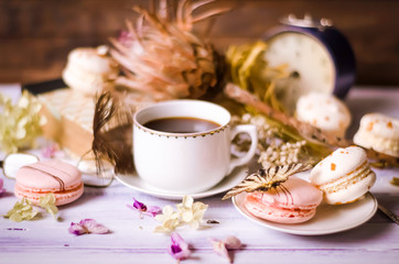 Obraz na płótnie Canvas Cup of coffee with macaroons, dried flowers protea