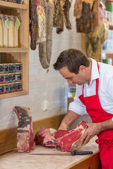 Butcher Preparing Meat In Shop
