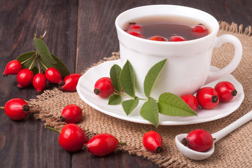 Tea from the hips on the wooden background