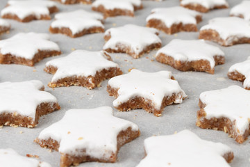 Making self-made christmas star cinnamon cookie, closeup, low focus