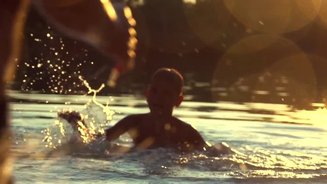 Little boys having fun in water outdoors. Happy joyful children. Slow motion 240 fps, HD 1080p