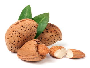 almonds in their skins and peeled with leaf isolated on white background