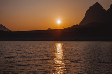 Fototapeta na wymiar The mountains and lake scenery in sunset