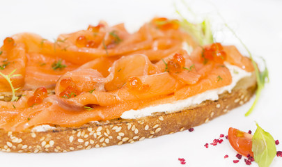 Sandwiches with salmon caviar and greens adorned
