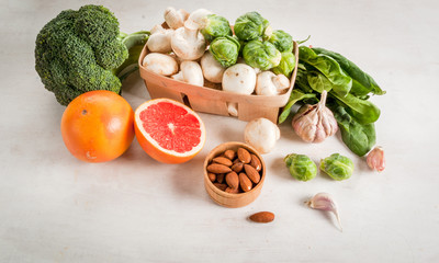 Selection of products to enhance the health and immunity: broccoli, mushrooms, mushrooms, Brussels sprouts, spinach, garlic, almonds and grapefruit, copy space
