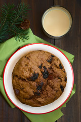 Traditional Chilean Pan de Pascua Christmas cake with a glass of Cola de Mono Christmas cocktail, photographed with natural light (Selective Focus, Focus on the top of the cake)