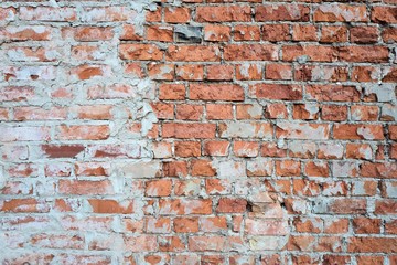 weathered brick wall with residues of plaster for background use