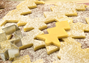 cooking cookie dough in the shape of a Christmas tree sprinkled