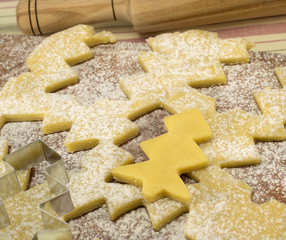 cooking cookie dough in the shape of a Christmas tree sprinkled
