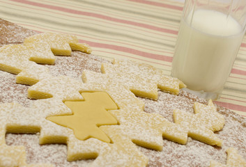 cooking cookie dough in the shape of a Christmas tree topped wit
