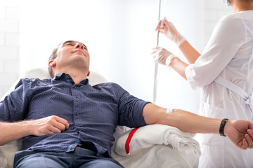 Male patient getting intravenous procedure in hospital