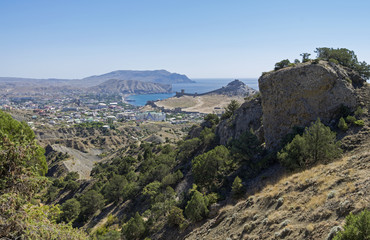 Fototapeta na wymiar View of the resort town from a mountainside. Crimea, September.