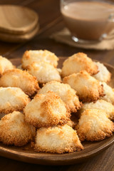 Coconut macaroons (meringue cookies), traditional German Christmas cookies Kokosmakronen, photographed with natural light (Selective Focus, Focus on the front of the first macaroons)