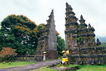 Traditional Balinese Hindu gate at rainy summer day with clouds - Candi Bentar, Bedugul in Bali...
