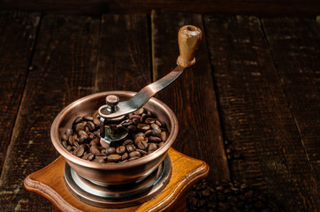 Close-up coffee mill on old rustic background.