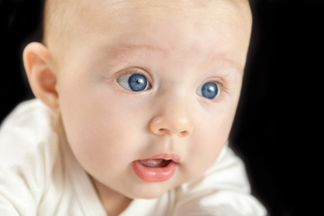 adorable happy baby on black background