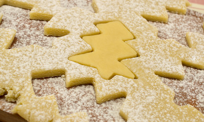cooking cookie dough in the shape of a Christmas tree sprinkled