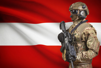 Soldier in helmet holding machine gun with flag on background series - Austria