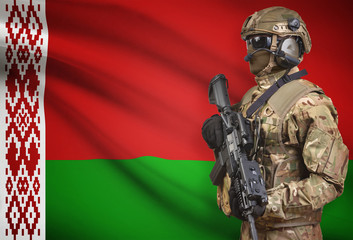 Soldier in helmet holding machine gun with flag on background series - Belarus