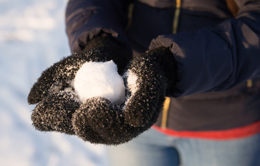 Girl holding snowball.
