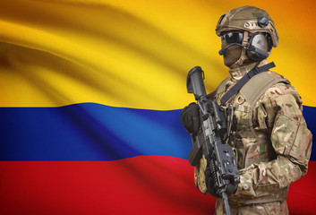 Soldier in helmet holding machine gun with flag on background series - Colombia