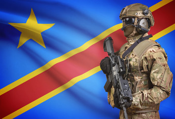 Soldier in helmet holding machine gun with flag on background series - Congo-Kinshasa