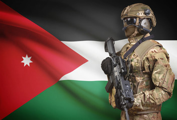 Soldier in helmet holding machine gun with flag on background series - Jordan