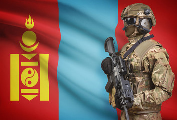 Soldier in helmet holding machine gun with flag on background series - Mongolia