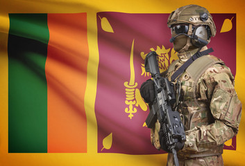 Soldier in helmet holding machine gun with flag on background series - Sri Lanka