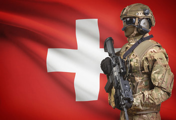 Soldier in helmet holding machine gun with flag on background series - Switzerland