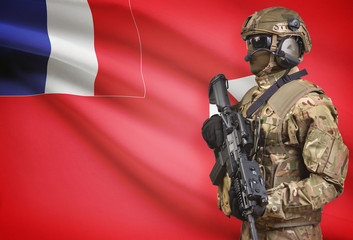 Soldier in helmet holding machine gun with flag on background series - Wallis and Futuna