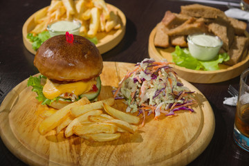 Burgers And Glasses Of Whiskey On Wooden Plates