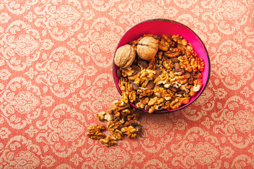 Bowl with walnuts on baroque background